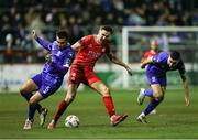 18 October 2024; Sean Boyd of Shelbourne in action against Grant Horton, left, and Darragh Leahy of Waterford during the SSE Airtricity Men's Premier Division match between Shelbourne and Waterford at Tolka Park in Dublin. Photo by Thomas Flinkow/Sportsfile