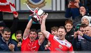 20 October 2024; Pádraig Pearses captain Niall Daly, right, lifts the cup with team-mate Caelim Keogh after their side's victory in the Roscommon County Senior Club Football Championship final match between Pádraig Pearses and Roscommon Gaels at Dr Hyde Park in Roscommon. Photo by Piaras Ó Mídheach/Sportsfile