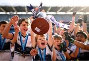 21 October 2024; Zach Moonman of Grace Park Educate Together National School lifts the trophy after his side defeated Scoil Ghrainne Community National School, Dublin, on day one of the Allianz Cumann na mBunscol Finals at Croke Park in Dublin. Photo by Ramsey Cardy/Sportsfile