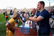 22 October 2024; Dublin footballer Ciaran Kilkenny awards the medal to winning captain Andrea Inglis of St. Patrick's NS, Diswellstown, Dublin, during day two of the Allianz Cumann na mBunscol Finals at Croke Park in Dublin. Photo by Ramsey Cardy/Sportsfile