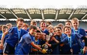 22 October 2024; Holy Cross NS players celebrate with the trophy after the match between Holy Cross NS, Dundrum, Dublin and Sacred Heart NS, Sruleen, Dublin, on day two of the Allianz Cumann na mBunscol Finals at Croke Park in Dublin. Photo by Ramsey Cardy/Sportsfile