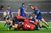 26 October 2024; Leinster players including Josh van der Flier, right, celebrate as Caelan Doris of Leinster, hidden, scores his side's second try during the United Rugby Championship match between Leinster and Emirates Lions at the Aviva Stadium in Dublin. Photo by Sam Barnes/Sportsfile