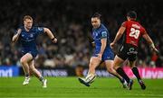 26 October 2024; James Lowe of Leinster, supported by teammate Hugh Cooney, left, kicks past Erich Cronje of Emirates Lions during the United Rugby Championship match between Leinster and Emirates Lions at the Aviva Stadium in Dublin. Photo by Brendan Moran/Sportsfile