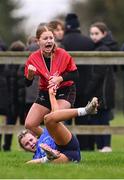 30 October 2024; Mackenzie Crowley of North East celebrates scoring her side's first try, as Lily Harney of North Midlands looks on, during the BearingPoint Sarah Robinson Cup Round 2 match between North East and North Midlands at Cill Dara RFC in Kildare. Photo by Piaras Ó Mídheach/Sportsfile