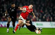 2 November 2024; Tom Farrell of Munster is tackled by Devan Flanders of All Blacks XV during the match between Munster and All Blacks XV at Thomond Park in Limerick. Photo by Brendan Moran/Sportsfile