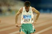 25 August 2004; A disappointed Mark Carroll of Ireland after finishing his heat of the Men's 5000m and failing to qualify for the final. Olympic Stadium. Games of the XXVIII Olympiad, Athens Summer Olympics Games 2004, Athens, Greece. Picture credit; Brendan Moran / SPORTSFILE