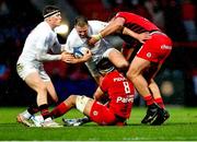 8 December 2024; Stuart McCloskey of Ulster is tackled by Alexandre Roumat and Emmanuel Meafou of Toulouse during the Champions Cup Round 1 match between Toulouse and Ulster at Stade Ernest Wallon in Toulouse, France. Photo by John Dickson/Sportsfile