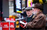 26 December 2024; Two Racegoers inspect the odds board on day one of the Leopardstown Christmas Festival at Leopardstown Racecourse in Dublin. Photo by Shauna Clinton/Sportsfile