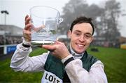 27 December 2024; Jockey J J Slevin celebrates with the trophy after winning the Paddy's Rewards Club Steeplechase (Grade 1) 5-y-o plus aboard Solness on day two of the Leopardstown Christmas Festival at Leopardstown Racecourse in Dublin. Photo by David Fitzgerald/Sportsfile