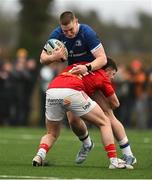 27 December 2024; Connor Fahy of Leinster A is tackled by Eoghan Smyth of Munster A during the A Interprovincial Rugby Championship match between Munster A and Leinster A at New Ormond Park in Nenagh, Tipperary. Photo by Brendan Moran/Sportsfile