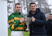 27 December 2024; Jockey Mark Walsh is presented the trophy by golfer Padraig Harrington after winning the Paddy Power Steeple chase 5-y-o plus aboard Perceval Legallois on day two of the Leopardstown Christmas Festival at Leopardstown Racecourse in Dublin. Photo by David Fitzgerald/Sportsfile