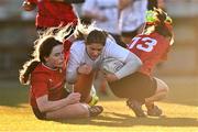 2 January 2025; Sophie McDonagh of Midlands is tackled by Emma O'Rourke, left, and Anna Allison of North East during the BearingPoint Sarah Robinson Cup Round 3 match between Midlands and North East at Shay Murtagh Park in Mullingar, Westmeath. Photo by Ben McShane/Sportsfile