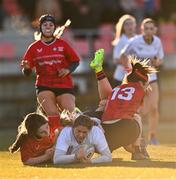 2 January 2025; Sophie McDonagh of Midlands is tackled by Emma O'Rourke, left, and Anna Allison of North East during the BearingPoint Sarah Robinson Cup Round 3 match between Midlands and North East at Shay Murtagh Park in Mullingar, Westmeath. Photo by Ben McShane/Sportsfile