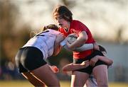 2 January 2025; Emma O'Rourke of North East is tackled by Sophie McDonagh, left, and Emma Wiseman of Midlands during the BearingPoint Sarah Robinson Cup Round 3 match between Midlands and North East at Shay Murtagh Park in Mullingar, Westmeath. Photo by Ben McShane/Sportsfile