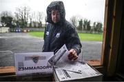 4 January 2025; A spectator takes a teamsheet before the Intercounty Hurling Challenge Match between Waterford and Cork at Fraher Field in Dungarvan, Waterford. Photo by Seb Daly/Sportsfile