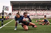 4 January 2025; Katie Corrigan of Wolfhounds scores her side's second try despite the tackle of Grace Deane of Glasgow Warriors during the Celtic Challenge match between Wolfhounds and Glasgow Warriors at Kingspan Stadium in Belfast. Photo by Ramsey Cardy/Sportsfile