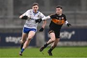 4 January 2025; Ruairi Forbes of Ballinderry in action against Paddy Lane of Austin Stacks during the AIB GAA Football All-Ireland Intermediate Club Championship semi-final match between Austin Stacks and Ballinderry at Parnell Park in Dublin. Photo by Ben McShane/Sportsfile