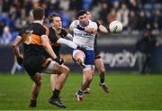 4 January 2025; Daniel McKinless of Ballinderry scores a point despite the efforts of Colm Browne of Austin Stacks during the AIB GAA Football All-Ireland Intermediate Club Championship semi-final match between Austin Stacks and Ballinderry at Parnell Park in Dublin. Photo by Ben McShane/Sportsfile