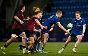 4 January 2025; Connor Fahy of Leinster offloads the ball to team-mate Ruben Moloney despite the tackle of Sam Wisniewski of Ireland during the friendly match between Ireland U20 and Leinster Development XV at Energia Park in Dublin. Photo by Ben McShane/Sportsfile