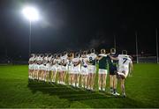 4 January 2025; Kildare players stand for Amhrán na bhFiann, as Kevin Flynn, 7, gets a stretch in before the Intercounty Football Challenge match between Kildare and Galway at Cedral St Conleth's Park in Newbridge, Kildare. Photo by Piaras Ó Mídheach/Sportsfile