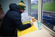 4 January 2025; Clubber commentator Shane McGrath prepares his teamsheets before the Intercounty Hurling Challenge Match between Waterford and Cork at Fraher Field in Dungarvan, Waterford. Photo by Seb Daly/Sportsfile