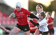 2 January 2025; Erin McFadden of North East evades the tackle of Emma Maher of Midlands during the BearingPoint Sarah Robinson Cup Round 3 match between Midlands and North East at Shay Murtagh Park in Mullingar, Westmeath. Photo by Ben McShane/Sportsfile