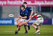 7 January 2025; Henry Regan of Wilson's Hospital offloads despite the tackle of Sam Heyes of St Columba’s College during the Bank of Ireland Leinster Rugby Boys Schools Vinnie Murray Cup 1st Round match between St Columba’s College and Wilson’s Hospital School at Energia Park in Dublin. Photo by Ben McShane/Sportsfile