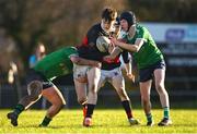 16 January 2025; Cormac Kilroy of The High School is tackled by Fionn Carey, left, and Oisín Gavin of Coláiste Mhuire CBS, Mullingar, during the Bank of Ireland Leinster Rugby Boys Schools Fr Godfrey Cup second round match between Coláiste Mhuire CBS, Mullingar and The High School, Dublin at De La Salle Palmerston FC in Kilternan, Dublin. Photo by Shauna Clinton/Sportsfile