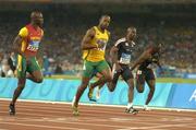 22 August 2004; Asafa Powell (2241) of Jamaica crosses the line to win the Men's 100m Semi-final from Francis Obikwelu (2739) of Portugal and Kim Collins (3003) of St Kitts and Nevis. Olympic Stadium. Games of the XXVIII Olympiad, Athens Summer Olympics Games 2004, Athens, Greece. Picture credit; Brendan Moran / SPORTSFILE