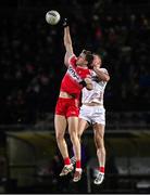 25 January 2025; Anton Tohill of Derry and Brian Kennedy of Tyrone contest the throw-in during the Allianz Football League Division 1 match between Tyrone and Derry at O'Neills Healy Park in Omagh, Tyrone. Photo by Ramsey Cardy/Sportsfile