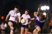 28 January 2025; Diarmuid Moriarty of UCD kicks a point despite the efforts of Matthew Nee of MTU Kerry during the Electric Ireland Higher Education GAA Sigerson Cup quarter-final match between University College Dublin and Munster Technological University Kerry at Billings Park in Belfield, Dublin. Photo by Thomas Flinkow/Sportsfile