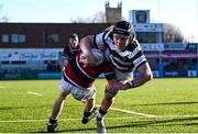 31 January 2025; Paul Dunne of Belvedere College dives over to score his side's first try despite the efforts of Jack Duffy of Wesley College during the Bank of Ireland Leinster Rugby Boys Schools Senior Cup first round match between Belvedere College and Wesley College at Energia Park in Dublin. Photo by Tyler Miller/Sportsfile