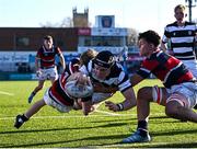 31 January 2025; Paul Dunne of Belvedere College dives over to score his side's first try despite the efforts of Jack Duffy, left, and Thibault Campbell of Wesley College during the Bank of Ireland Leinster Rugby Boys Schools Senior Cup first round match between Belvedere College and Wesley College at Energia Park in Dublin. Photo by Tyler Miller/Sportsfile