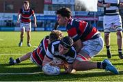 31 January 2025; Paul Dunne of Belvedere College dives over to score his side's first try despite the efforts of Jack Duffy, left, and Thibault Campbell of Wesley College during the Bank of Ireland Leinster Rugby Boys Schools Senior Cup first round match between Belvedere College and Wesley College at Energia Park in Dublin. Photo by Tyler Miller/Sportsfile