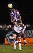 31 January 2025; Aaron Harper Bailey of Drogheda United wins a header above Leo Gaxha of Dundalk during the Jim Malone Cup match between Dundalk and Drogheda United at Oriel Park in Dundalk, Louth. Photo by Piaras Ó Mídheach/Sportsfile