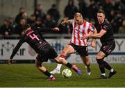 31 January 2025; Mark Connolly of Derry City in action against Donal Rocks, left, and Stephen O'Donnell, right, of Ballymena United during the pre-season friendly match between Derry City and Ballymena United at the Ryan McBride Brandywell Stadium in Derry. Photo by Stephen McCarthy/Sportsfile