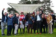 1 February 2025; Hello Neighbour, centre, with jockey Keith Donoghue, winning connections and trainer Gavin Cromwell after victory in the Gannon`s City Recovery & Recycling Services Juvenile Hurdle during day one of the Dublin Racing Festival at Leopardstown Racecourse in Dublin. Photo by Shauna Clinton/Sportsfile