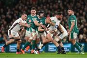 1 February 2025; Ellis Genge of England is tackled by Caelan Doris and Josh van der Flier of Ireland during the Guinness Six Nations Rugby Championship match between Ireland and England at Aviva Stadium in Dublin. Photo by Ramsey Cardy/Sportsfile