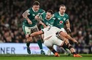 1 February 2025; Hugo Keenan of Ireland is tackled by George Martin of England during the Guinness Six Nations Rugby Championship match between Ireland and England at Aviva Stadium in Dublin. Photo by Brendan Moran/Sportsfile