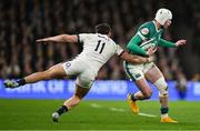 1 February 2025; Mack Hansen of Ireland is tackled by Cadan Murley of England during the Guinness Six Nations Rugby Championship match between Ireland and England at Aviva Stadium in Dublin. Photo by Brendan Moran/Sportsfile