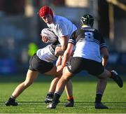 4 February 2025; Ruadhán Murray of Presentation College, Bray is tackled by Adam Hathaway, left, and Saul Brewster of Newbridge College during the Bank of Ireland Leinster Rugby Boys Schools Junior Cup First Round match between Newbridge College and Presentation College, Bray at Energia Park in Dublin. Photo by Shauna Clinton/Sportsfile