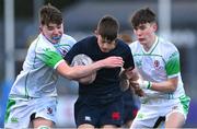 4 February 2025; Matthew Dignam of Wesley College is tackled by Callum Williamson, left, and Evan Doyle of Gonzaga College during the Bank of Ireland Leinster Rugby Boys Schools Junior Cup First Round match between Wesley College and Gonzaga College at Energia Park in Dublin. Photo by Shauna Clinton/Sportsfile