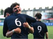 4 February 2025; Hlib Reznichenko of Wesley College, right, celebrates with team-mate Marius Pienaar after their side's victory in the Bank of Ireland Leinster Rugby Boys Schools Junior Cup First Round match between Wesley College and Gonzaga College at Energia Park in Dublin. Photo by Shauna Clinton/Sportsfile