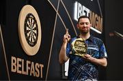 6 February 2025; Luke Humphries celebrates with the trophy after winning their final match against Chris Dobey on night one of the BetMGM Premier League Darts at SSE Arena in Belfast. Photo by Ben McShane/Sportsfile