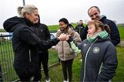 18 February 2025; Head coach Carla Ward with members of the Prosper Fingal Rush Football For All team, including Kim Doyle, right, after a Republic of Ireland women's training session at the FAI National Training Centre in Abbotstown, Dublin. Photo by Stephen McCarthy/Sportsfile