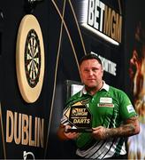 20 February 2025; Gerwyn Price celebrates with the trophy after winning their final match against Nathan Aspinall during night three of the BetMGM Premier League Darts at the 3 Arena in Dublin. Photo by Ben McShane/Sportsfile