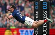 8 March 2025; Damian Penaud of France celebrates as he dives over to score his side's fifth try during the Guinness Six Nations Rugby Championship match between Ireland and France at the Aviva Stadium in Dublin. Photo by Seb Daly/Sportsfile