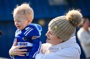 9 March 2025; Dáithí Dunphy, aged 1, and mum Niamh, family of Willie Dunphy of Laois, during the Allianz Hurling League Division 1B match between Antrim and Laois at Corrigan Park in Belfast. Photo by Ramsey Cardy/Sportsfile