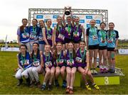 8 March 2025; The Mount Lourdes Enniskillen team celebrate with the cup alongside St Flannans Ennis who finished second and third place finishers Lumen Christi Derry in the Minor Girls 2,000m team event during the 123.ie All Ireland Schools Cross Country Championships at Galway Racecourse in Ballybrit, Galway. Photo by Tom Beary/Sportsfile