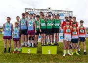 8 March 2025; St Malachys Belfast celebrate with the cup alongside second place finishers St Michaels Enniskillen and St Muredachs Ballina after competing in the Junior Boys 3,500m team event during the 123.ie All Ireland Schools Cross Country Championships at Galway Racecourse in Ballybrit, Galway. Photo by Tom Beary/Sportsfile